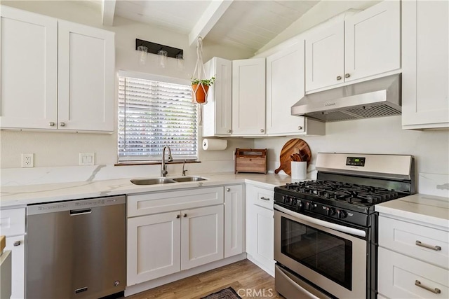 4095 Dolores Ave, Atascadero, CA 93422 - kitchen featuring stainless steel appliances, under cabinet range hood, white cabinetry, light stone countertops, and light wood-style flooring