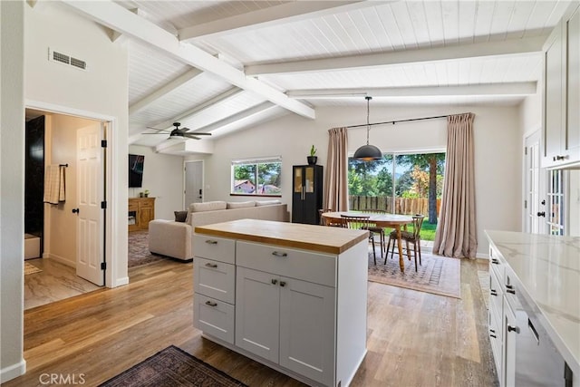 4095 Dolores Ave, Atascadero, CA 93422 - kitchen featuring light wood-style flooring, ceiling fan, hanging light fixtures, wood counters, and open floor plan