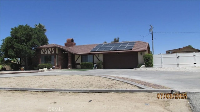 19824 Yucca Loma Rd, Apple Valley, CA 92307 - view of front facade with roof mounted solar panels, a chimney, stucco siding, and a tiled roof