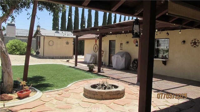19824 Yucca Loma Rd, Apple Valley, CA 92307 - view of patio / terrace with area for grilling, a fire pit, and an outbuilding