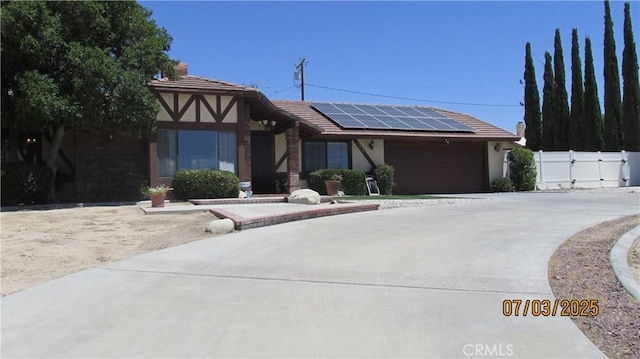 19824 Yucca Loma Rd, Apple Valley, CA 92307 - view of front of home featuring solar panels, stucco siding, a tiled roof, driveway, and a gate