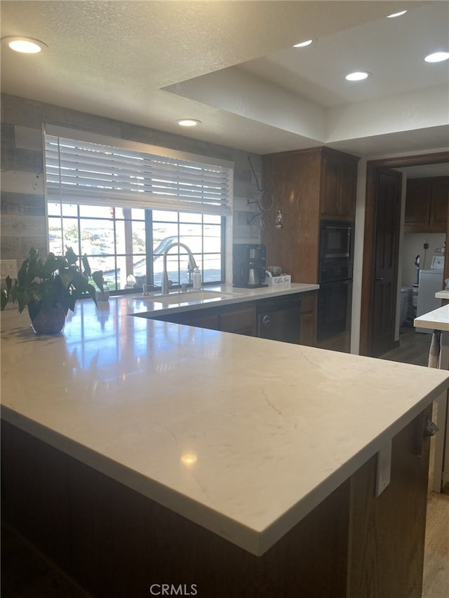 19824 Yucca Loma Rd, Apple Valley, CA 92307 - kitchen with black appliances, washer / clothes dryer, recessed lighting, a peninsula, and wood finished floors
