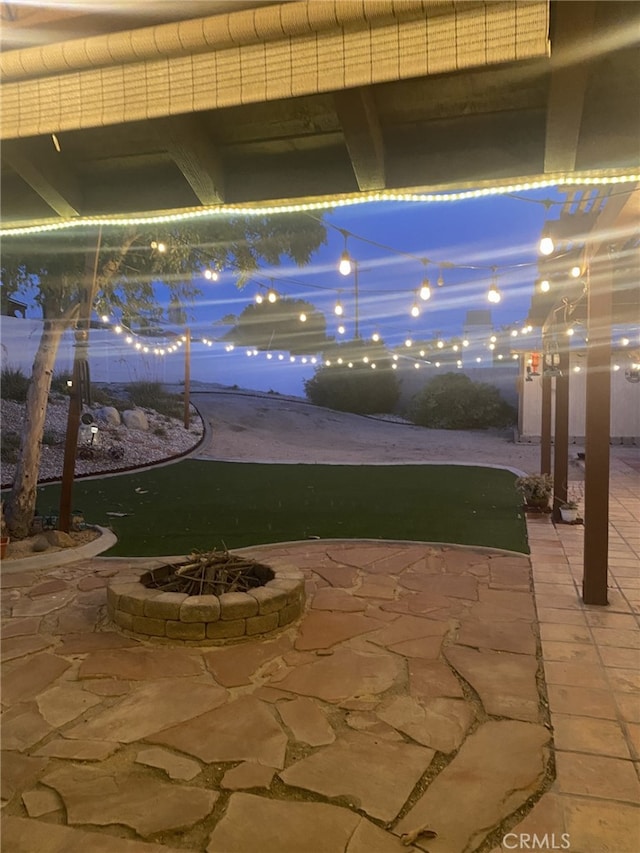 19824 Yucca Loma Rd, Apple Valley, CA 92307 - patio at night with an outdoor fire pit and a patio area