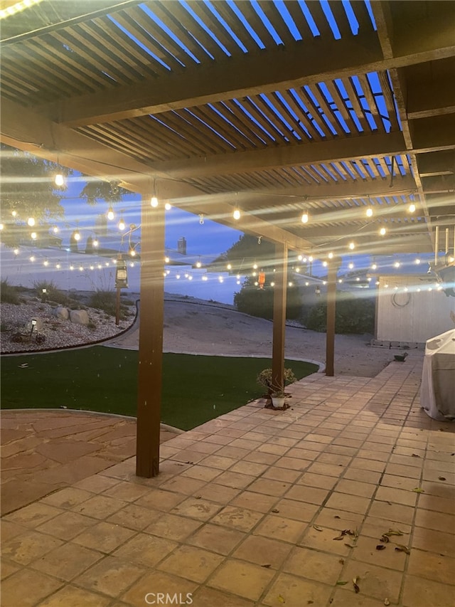19824 Yucca Loma Rd, Apple Valley, CA 92307 - patio at twilight featuring a patio and a pergola