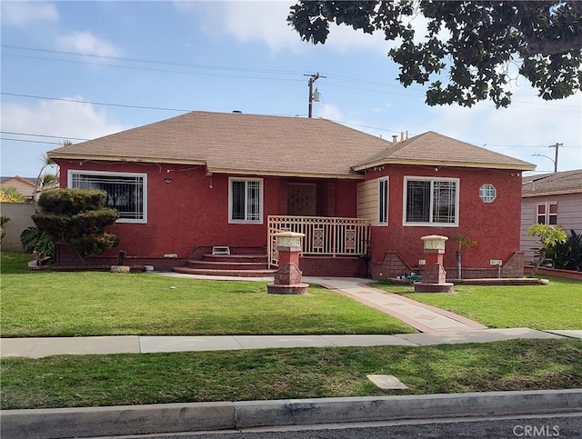 11028 Spinning Ave, Inglewood, CA 90303 - bungalow-style home with a front yard, stucco siding, covered porch, and a shingled roof