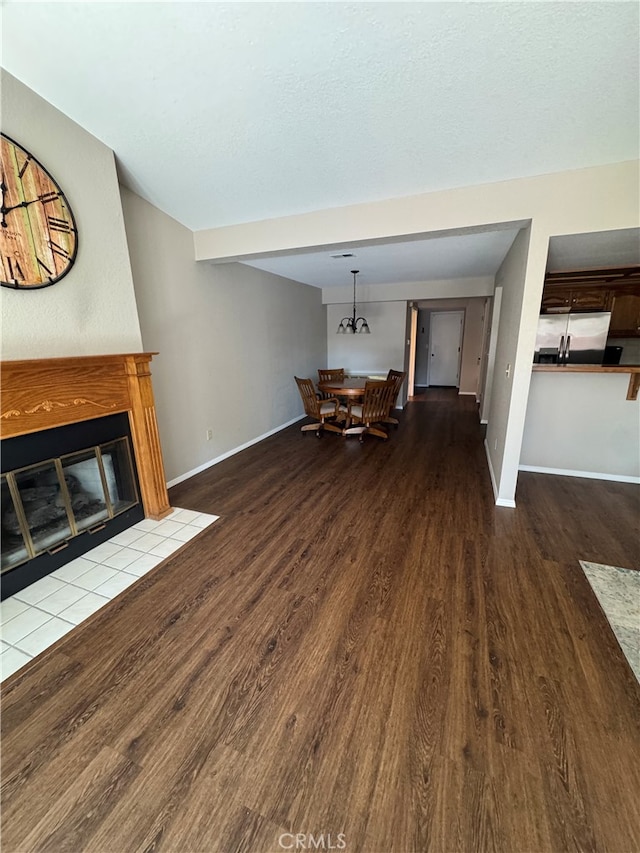 261 Spruce St Unit B, Arroyo Grande, CA 93420 - unfurnished living room with dark wood-style flooring and a fireplace with flush hearth