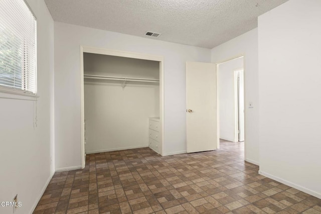 1543 Mobil Ave, Camarillo, CA 93010 - unfurnished bedroom featuring brick patterned floors, a closet, and a textured ceiling