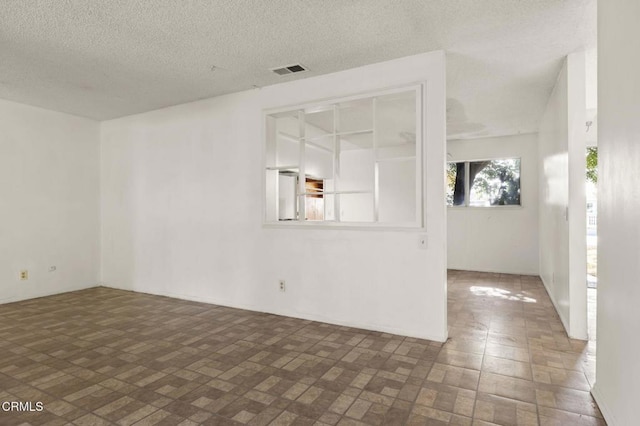 1543 Mobil Ave, Camarillo, CA 93010 - empty room featuring brick patterned flooring and a textured ceiling