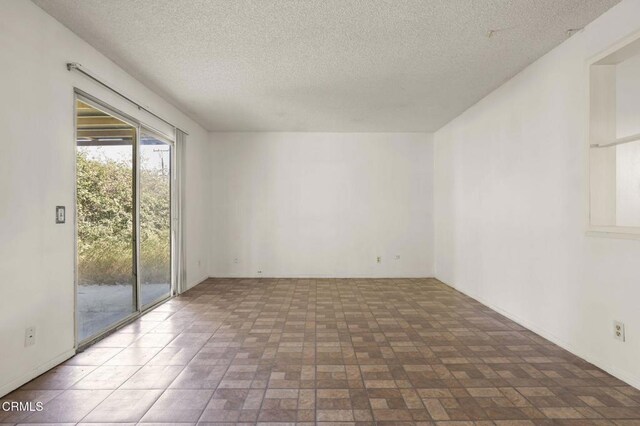 1543 Mobil Ave, Camarillo, CA 93010 - empty room featuring a textured ceiling and brick patterned flooring
