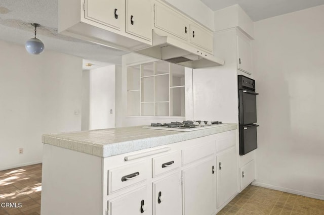 1543 Mobil Ave, Camarillo, CA 93010 - kitchen featuring light countertops, under cabinet range hood, white gas cooktop, white cabinets, and a peninsula