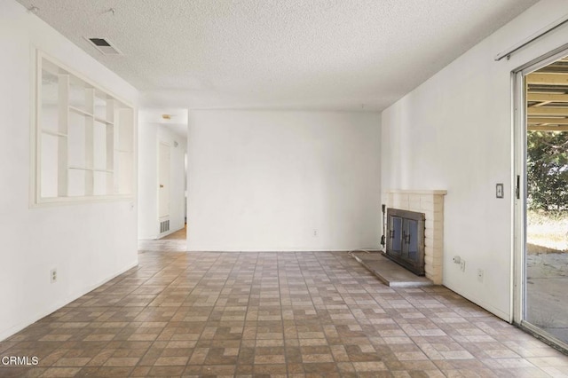 1543 Mobil Ave, Camarillo, CA 93010 - unfurnished living room featuring a brick fireplace, a textured ceiling, and brick patterned floors