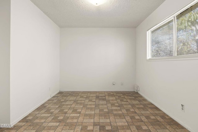 1543 Mobil Ave, Camarillo, CA 93010 - empty room with a textured ceiling and brick patterned flooring