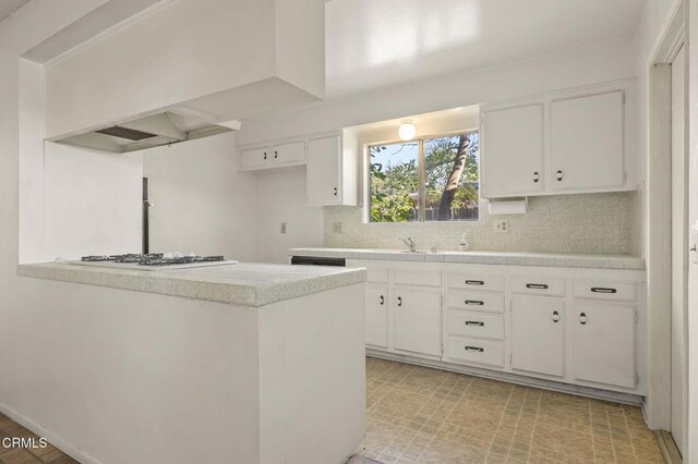 1543 Mobil Ave, Camarillo, CA 93010 - kitchen with white gas stovetop, light countertops, white cabinetry, backsplash, and light floors