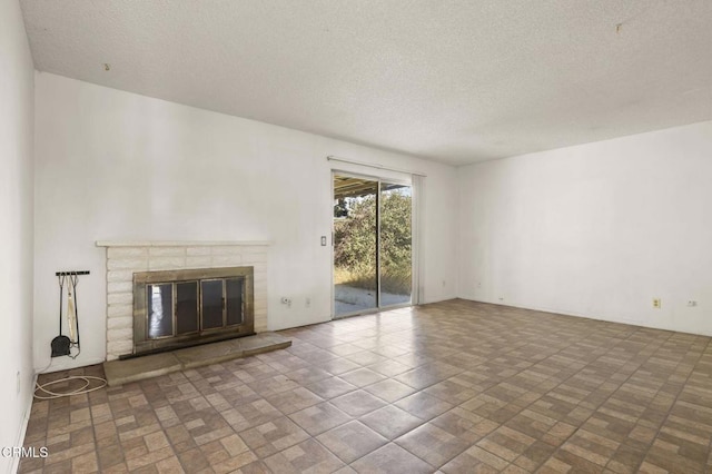 1543 Mobil Ave, Camarillo, CA 93010 - unfurnished living room with a textured ceiling, a glass covered fireplace, and brick patterned flooring