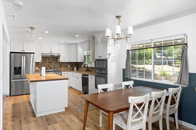 835 Minor Dr, Escondido, CA 92025 - kitchen featuring black appliances, butcher block countertops, a chandelier, decorative backsplash, and white cabinets