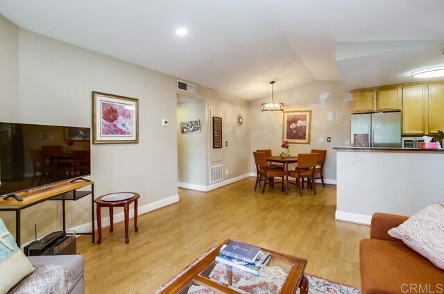 3635 Grove St Unit 268, Lemon Grove, CA 91945 - living room featuring lofted ceiling, light wood finished floors, and a chandelier