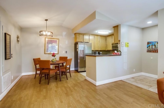 3635 Grove St Unit 268, Lemon Grove, CA 91945 - kitchen featuring appliances with stainless steel finishes, light wood-style floors, light brown cabinetry, a peninsula, and a chandelier