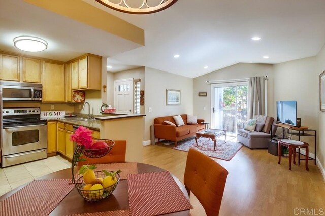 3635 Grove St Unit 268, Lemon Grove, CA 91945 - kitchen featuring stainless steel appliances, open floor plan, lofted ceiling, light brown cabinetry, and recessed lighting