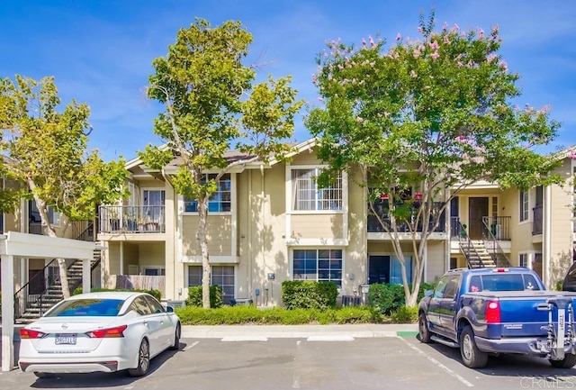 3635 Grove St Unit 268, Lemon Grove, CA 91945 - view of building exterior with stairs and uncovered parking
