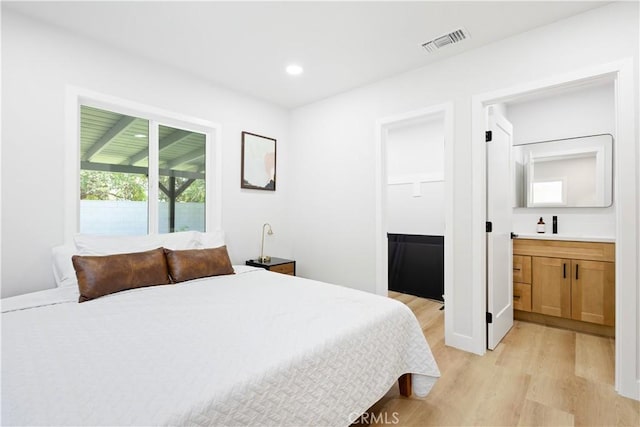 18746 Welby Way, Reseda, CA 91335 - bedroom featuring light wood-style flooring, ensuite bath, and recessed lighting