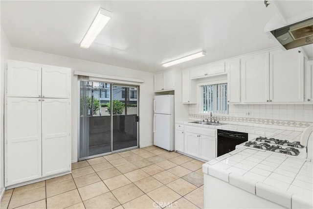 841 W 5th, San Pedro, CA 90731 - kitchen featuring freestanding refrigerator, tile countertops, black dishwasher, white cabinets, and plenty of natural light
