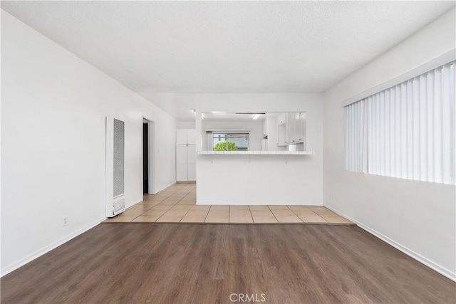 841 W 5th, San Pedro, CA 90731 - unfurnished living room with a heating unit and light wood-style flooring