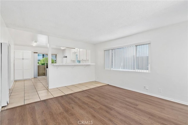 841 W 5th, San Pedro, CA 90731 - unfurnished living room with light wood-style flooring and a textured ceiling