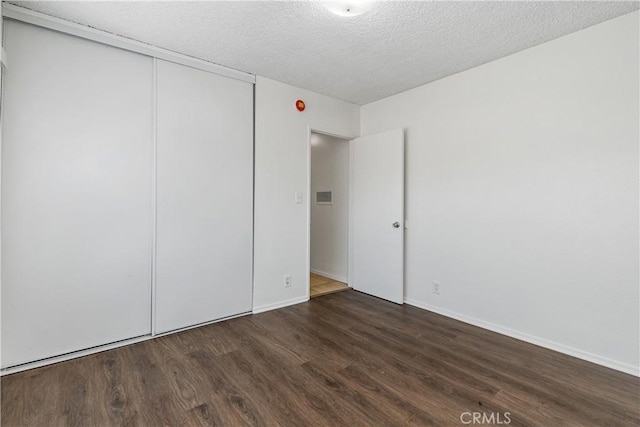 841 W 5th, San Pedro, CA 90731 - unfurnished bedroom featuring wood finished floors, a textured ceiling, and a closet