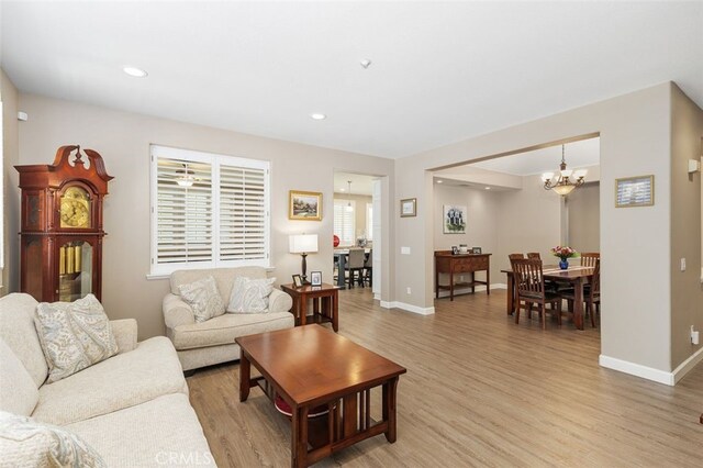 1647 Naranjo Ct, Redlands, CA 92374 - living room featuring light wood-style floors, a chandelier, recessed lighting, and plenty of natural light