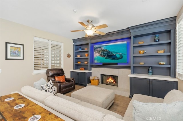 1647 Naranjo Ct, Redlands, CA 92374 - living area with built in features, a tile fireplace, ceiling fan, and wood finished floors