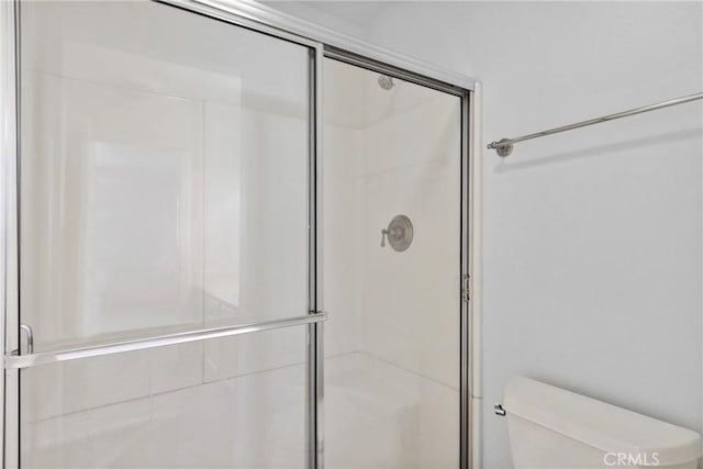 10166 Camino Ruiz Unit 32, San Diego, CA 92126 - bathroom featuring a shower with door and toilet