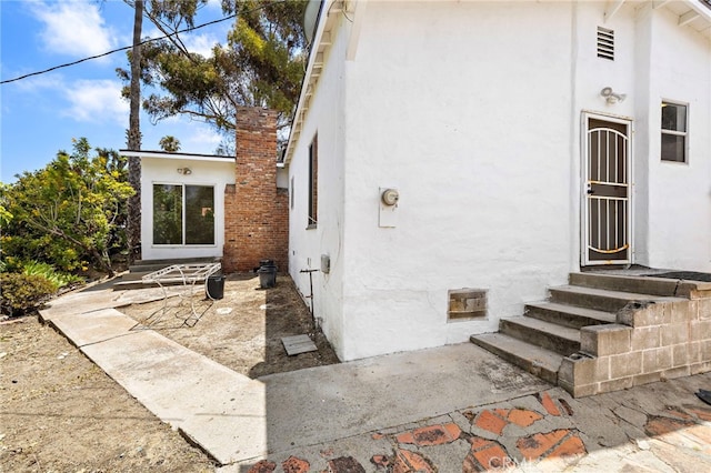 1509 N Avenida De La Estrella, San Clemente, CA 92672 - entrance to property featuring stucco siding, a chimney, and a patio