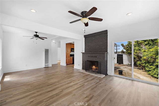 1509 N Avenida De La Estrella, San Clemente, CA 92672 - unfurnished living room featuring ceiling fan, a brick fireplace, light wood-style flooring, and recessed lighting
