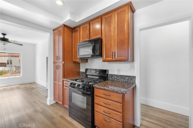 1509 N Avenida De La Estrella, San Clemente, CA 92672 - kitchen with black appliances, light wood-type flooring, dark stone counters, brown cabinets, and recessed lighting
