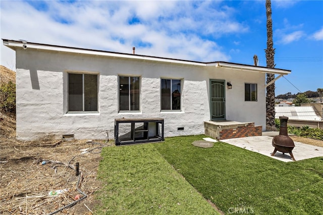 1509 N Avenida De La Estrella, San Clemente, CA 92672 - rear view of house featuring an outdoor fire pit, a lawn, crawl space, stucco siding, and a patio area
