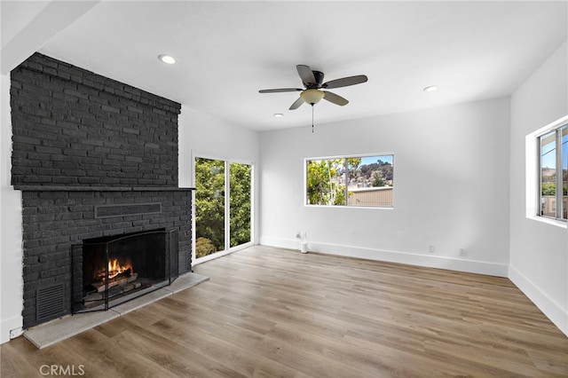 1509 N Avenida De La Estrella, San Clemente, CA 92672 - unfurnished living room featuring healthy amount of natural light, recessed lighting, a fireplace, wood finished floors, and a ceiling fan