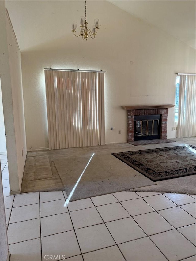 43644 Serenity Ct, Lancaster, CA 93535 - unfurnished living room featuring high vaulted ceiling, carpet flooring, a chandelier, tile patterned floors, and a brick fireplace