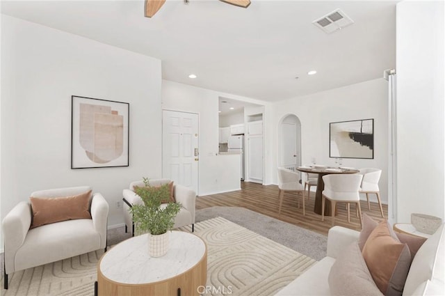 26390 Arboretum Way Unit 3004, Murrieta, CA 92563 - living area with arched walkways, a ceiling fan, wood finished floors, and recessed lighting