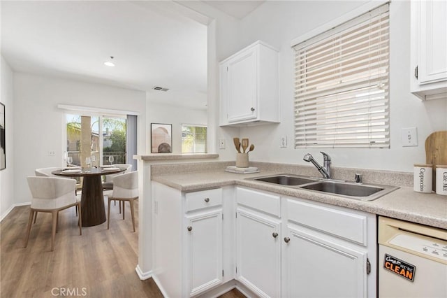 26390 Arboretum Way Unit 3004, Murrieta, CA 92563 - kitchen featuring dishwasher, wood finished floors, white cabinets, light countertops, and a peninsula