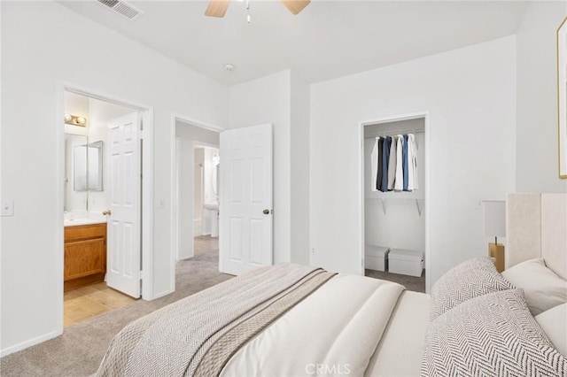 26390 Arboretum Way Unit 3004, Murrieta, CA 92563 - bedroom with light carpet, a walk in closet, connected bathroom, and ceiling fan