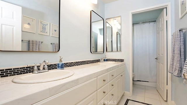 31962 Via Montura, San Juan Capistrano, CA 92675 - full bathroom featuring double vanity, tile patterned floors, a shower with curtain, and backsplash