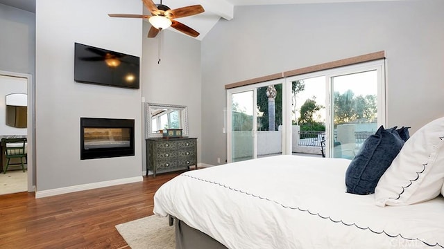 31962 Via Montura, San Juan Capistrano, CA 92675 - bedroom featuring access to outside, a glass covered fireplace, high vaulted ceiling, dark wood-style flooring, and beamed ceiling
