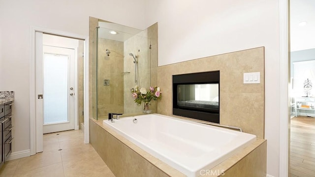 31962 Via Montura, San Juan Capistrano, CA 92675 - bathroom with a garden tub, a stall shower, vanity, tile patterned flooring, and a glass covered fireplace