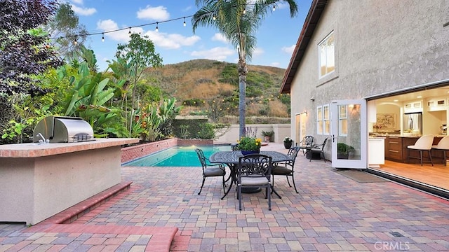 31962 Via Montura, San Juan Capistrano, CA 92675 - view of patio featuring an outdoor kitchen, a mountain view, and outdoor dining area