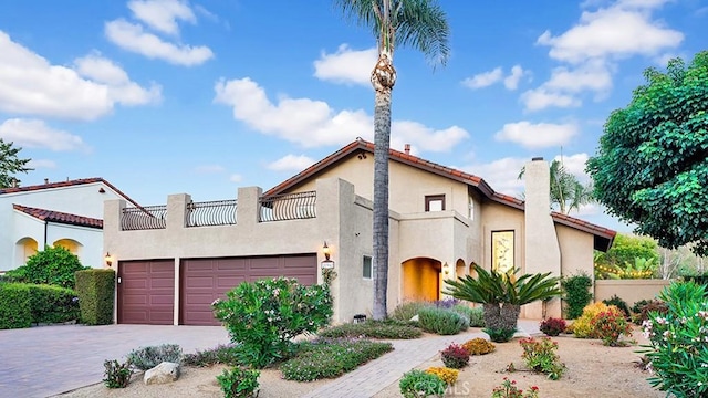31962 Via Montura, San Juan Capistrano, CA 92675 - mediterranean / spanish home featuring stucco siding, an attached garage, decorative driveway, and a chimney