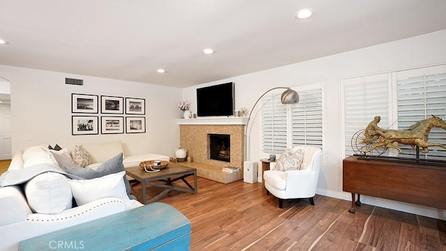 31962 Via Montura, San Juan Capistrano, CA 92675 - living room with wood finished floors, a fireplace with raised hearth, and recessed lighting