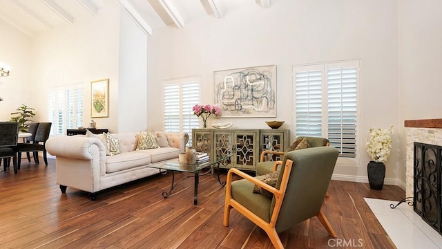 31962 Via Montura, San Juan Capistrano, CA 92675 - living area featuring beamed ceiling, plenty of natural light, a fireplace with flush hearth, high vaulted ceiling, and wood finished floors
