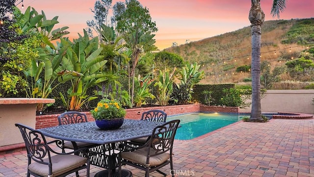 31962 Via Montura, San Juan Capistrano, CA 92675 - pool at dusk featuring a patio area, a jacuzzi, and outdoor dining area