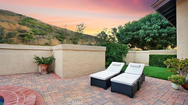 31962 Via Montura, San Juan Capistrano, CA 92675 - patio terrace at dusk featuring a patio area and a mountain view