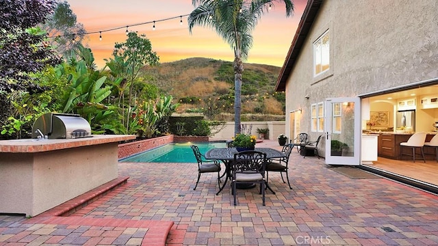 31962 Via Montura, San Juan Capistrano, CA 92675 - view of patio / terrace featuring exterior kitchen, a mountain view, and outdoor dining area